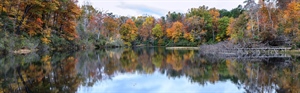 Panoramic of lake front with autumn trees